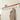 large white coat rack with shelf in a hallway displaying a coat and accessories.