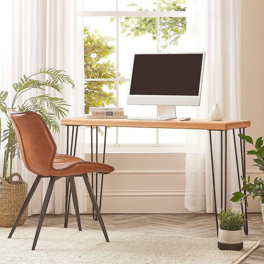 Solid oak computer desk with metal hairpin legs in a home office setting