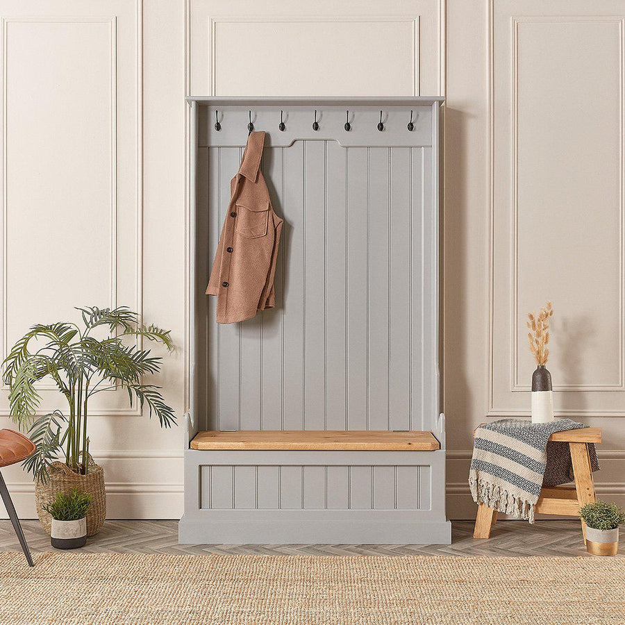Front view of a tall painted monks bench with coat hooks