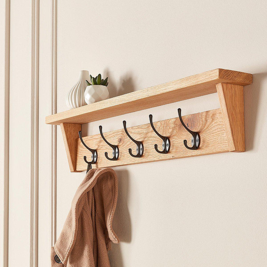 Handcrafted wooden coat rack with shelf, solid oak, made in Yorkshire, wall-mounted with cast-iron hooks.
